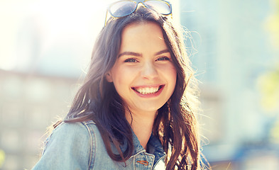 Image showing happy smiling young woman on summer city street