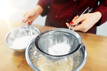 Image showing chef with flour in bowl making batter or dough