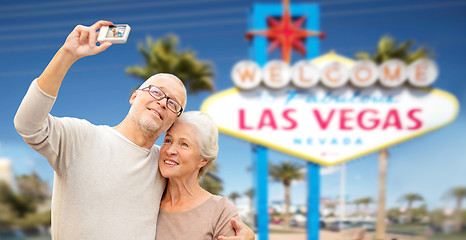 Image showing senior couple taking selfie by camera at las vegas