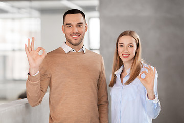 Image showing businesswoman and businessman showing ok at office