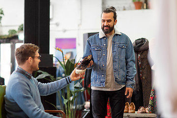 Image showing friends choosing shoes at vintage clothing store