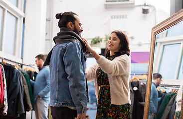 Image showing couple choosing clothes at vintage clothing store