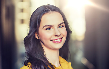 Image showing smiling young woman in city