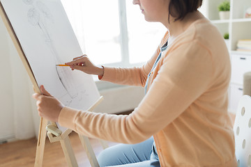 Image showing artist with pencil drawing picture at art studio