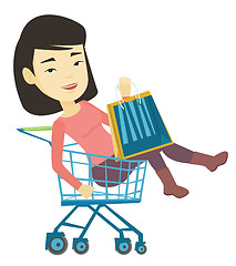 Image showing Happy woman riding by shopping trolley.