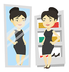 Image showing Woman trying on clothes in dressing room.