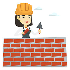 Image showing Bricklayer working with spatula and brick.