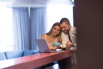 Image showing A young couple is preparing for a job and using a laptop