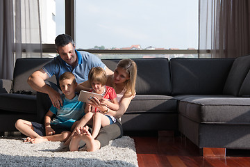 Image showing happy young couple spending time with kids