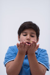 Image showing kid blowing confetti