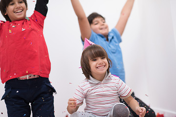 Image showing kids  blowing confetti