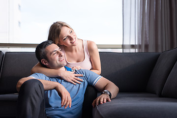 Image showing young handsome couple hugging on the sofa