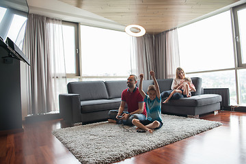 Image showing Happy family playing a video game