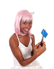 Image showing Smiling woman cuting her credit card