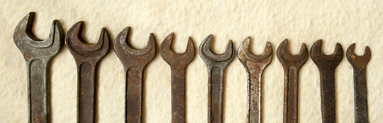 Image showing rusty old wrenches photographed to half
