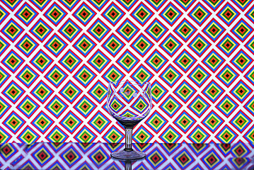 Image showing Glass wine glass on a background of squares