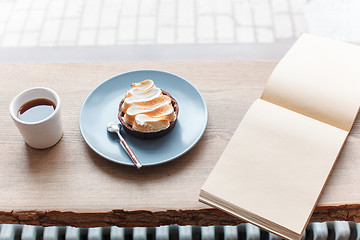 Image showing Cup of coffee, branch of tree, wooden windowsill