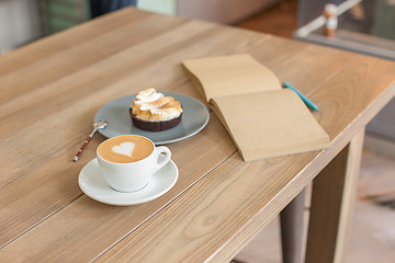 Image showing A table setting for coffee on the counter at a coffee house