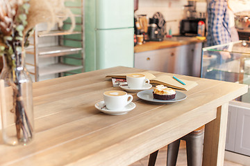 Image showing A table setting for coffee on the counter at a coffee house