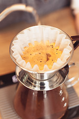 Image showing Hand drip coffee, Barista pouring water on coffee ground with filter