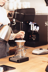 Image showing Hand drip coffee, Barista pouring water on coffee ground with filter