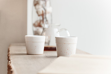 Image showing Cup of coffee, branch of tree, wooden windowsill