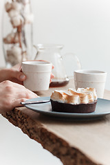 Image showing Cup of coffee, branch of tree, wooden windowsill