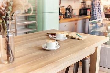 Image showing A table setting for coffee on the counter at a coffee house