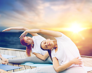 Image showing women doing yoga exercises outdoors