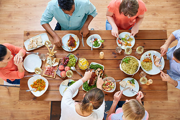 Image showing group of people eating chicken for dinner