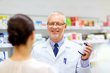 Image showing apothecary and woman with drug at pharmacy