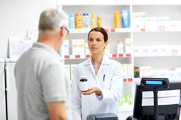 Image showing apothecary and senior customer at pharmacy