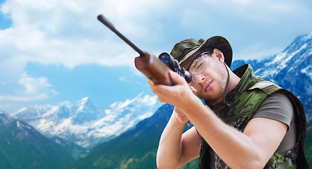 Image showing soldier or hunter with gun aiming or shooting