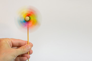 Image showing Multi-colored windmill and hand