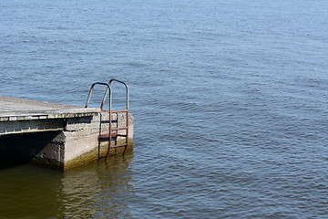 Image showing Rusted metal ladder on the side of a jetty