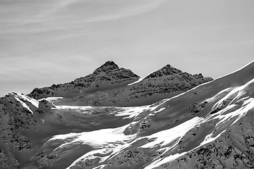 Image showing Black and white view on winter mountains with snow cornice at su