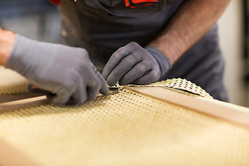 Image showing assembler with cutter making furniture