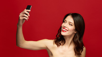 Image showing beautiful woman taking selfie with smartphone