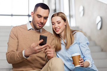 Image showing man and woman with smartphone at office stairs