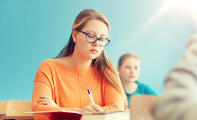 Image showing group of students with books writing school test