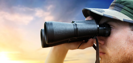 Image showing close up of soldier face looking to binocular