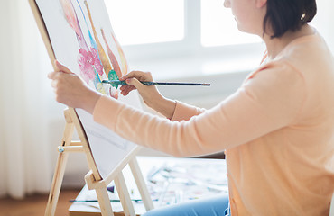 Image showing artist with brush painting still life at studio