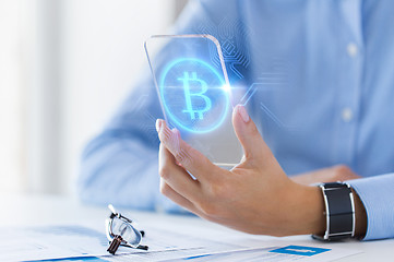 Image showing close up of bitcoin on transparent smartphone