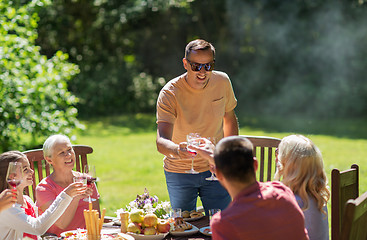 Image showing happy family having dinner or summer garden party