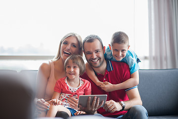 Image showing happy young couple spending time with kids