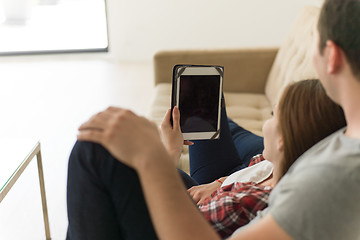 Image showing couple relaxing at  home with tablet computers