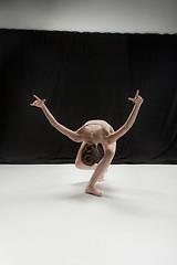 Image showing Young teen dancer on white floor background.