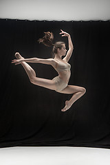 Image showing Young teen dancer on white floor background.