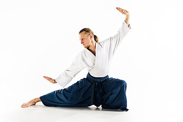 Image showing Aikido master practices defense posture. Healthy lifestyle and sports concept. Man with beard in white kimono on white background.