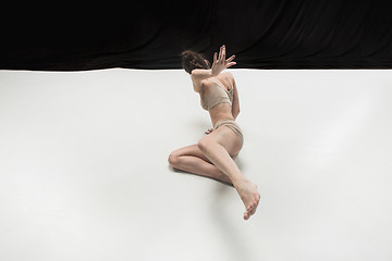 Image showing Young teen dancer on white floor background.